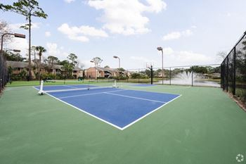 A tennis court with two nets on a blue and green court